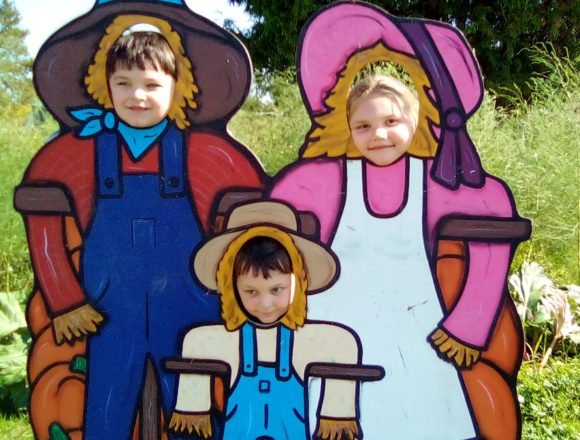 Justin, Oliver, and Olivia in their farmer's clothes.