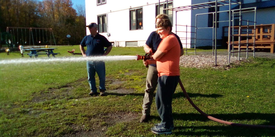 Reggie working the fire hose nozzle.