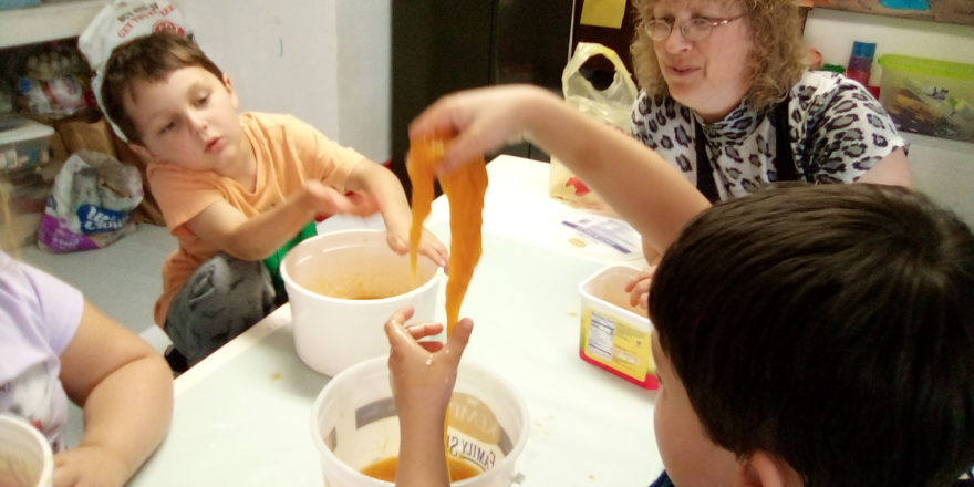 kids playing with the pumpkin guts after carving.