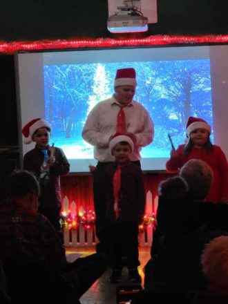 Justin, Oliver, Olivia, and Reggie (in background) singing Rudolph!!
