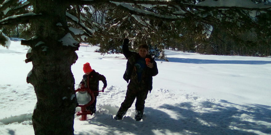 Justin and Reggie ringing the bell at Omer's Golf Course.