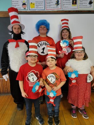 Justin, Oliver, Olivia, in front, and Mr. Greg (cat in the hat), Reggie (Thing 1), and Ms. J. wearing cat in the hat and thing crafts. 