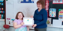 Okivia receives her reading month award.