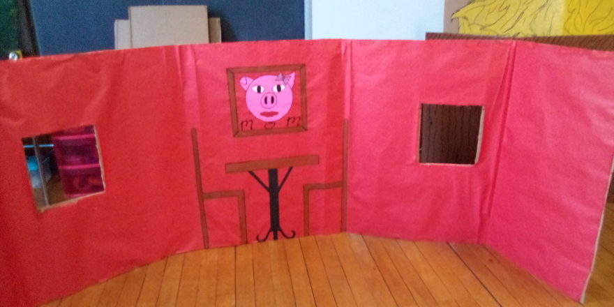 Spring thing 3 little pigs brick house interior with table, chairs, and Ms. pig picture.