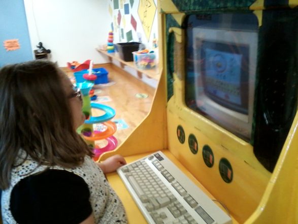 Olivia working the computer at the Children's Museum.