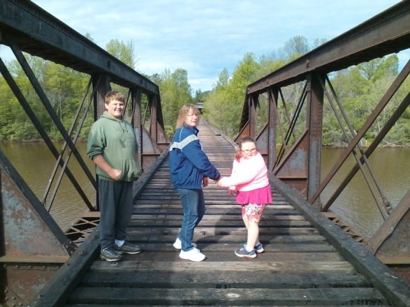 Reggie, Ms. J. and Olivia walking on the Ontonagon train bridge.