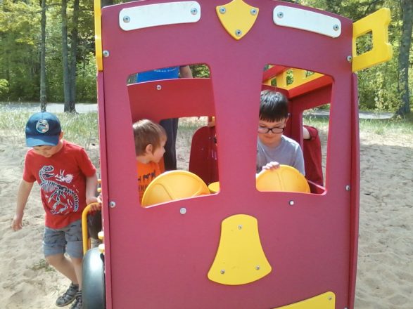Oliver and Justin playing in the fire truck at the plastic park in Ontonagon.