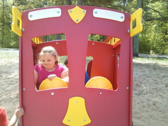 Olivia in the fire truck at the Ontonagon plastic park.