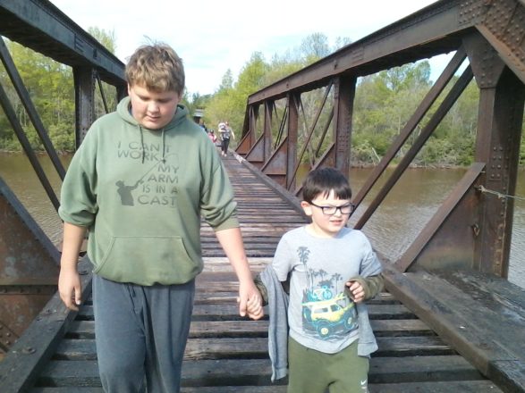 Reggie and Justin walking on the train bridge in Ontonagon.
