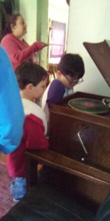 Oliver and Justin learning about a victrola record player at Old Victoria.