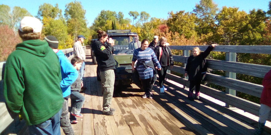 ORV ride on trestle bridge kids and Ms. Christine stop to look at the river.