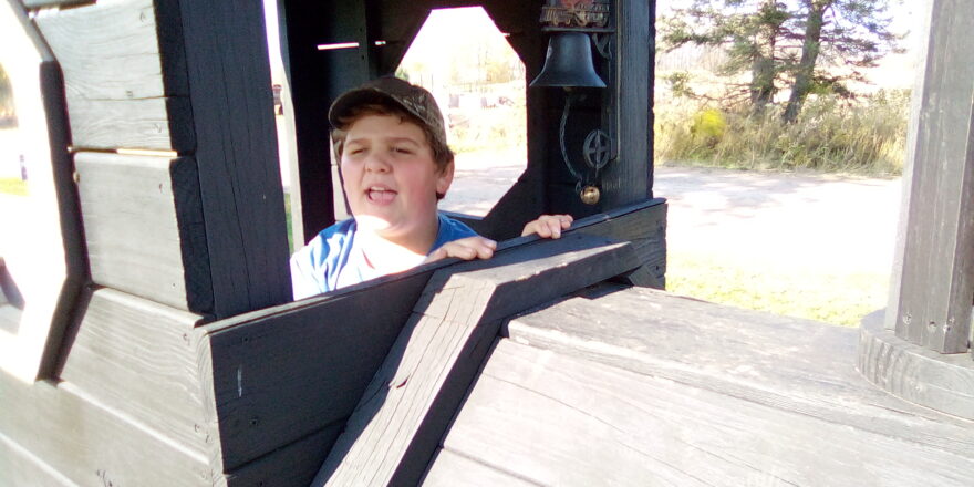 Reggie sitting in the conductors seat on the Hulkkonen Farm train.