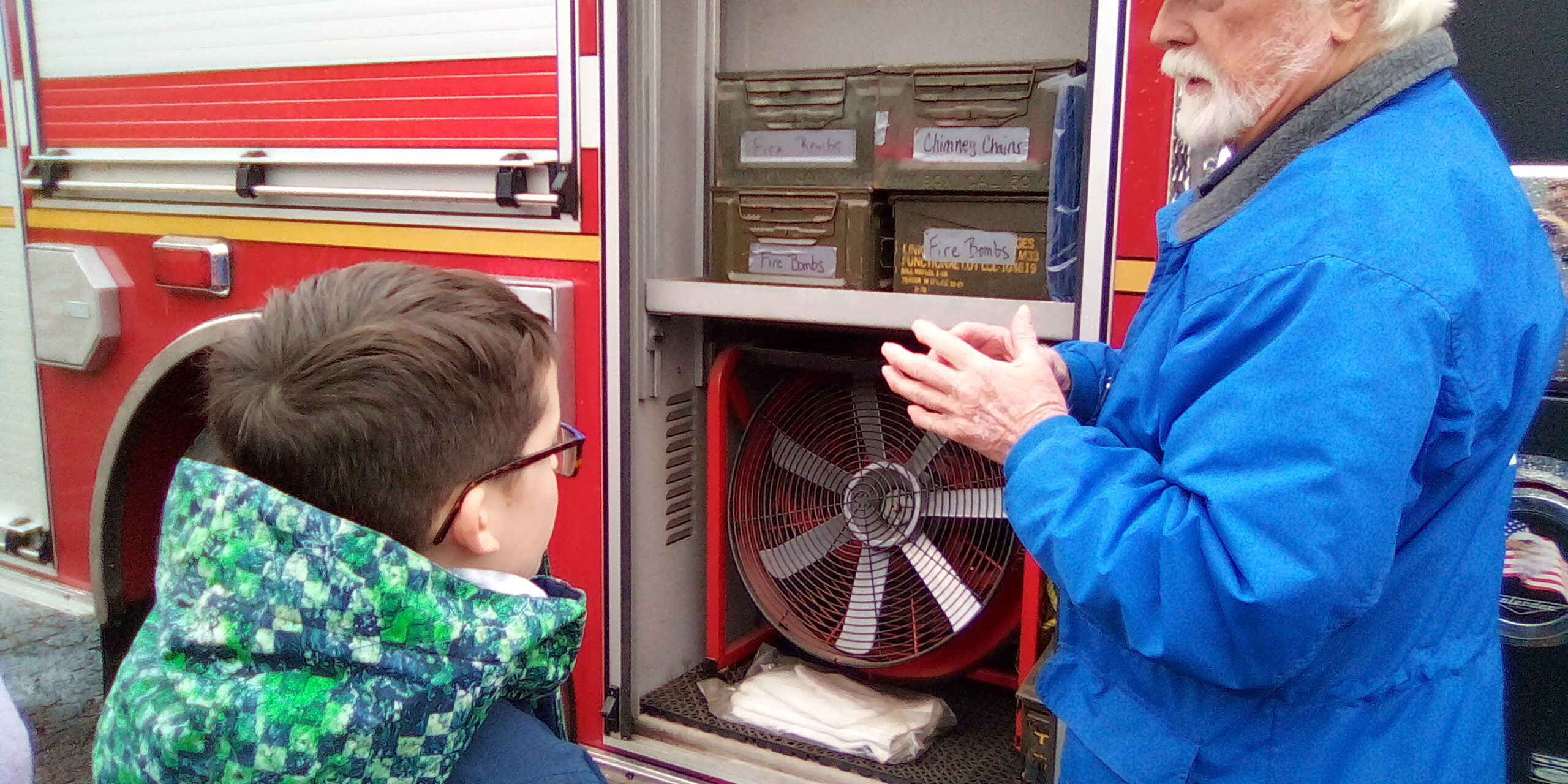 Avery learning about fire truck tools.