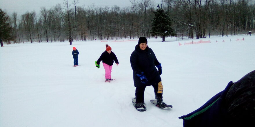 Ms. Christine giving the little kids a run for their money and showing them how to walk on snow.