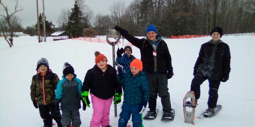 All the kids rang the silver bell at the Wyandot Golf Club at the beginning of their snowshoe hike.