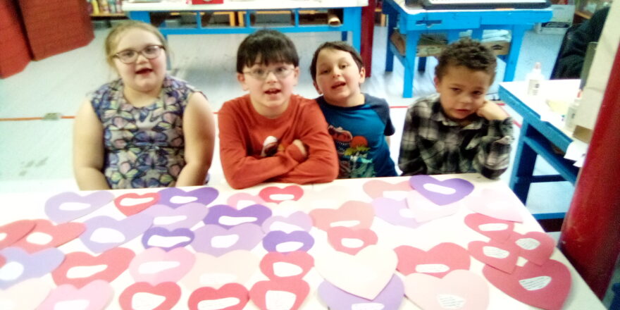 Art class kids working on making hearts to put their valentine poems on.
