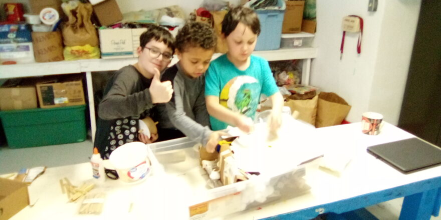 Avery, Landon, and Oliver trying to create a model for their science project about tsunami.
