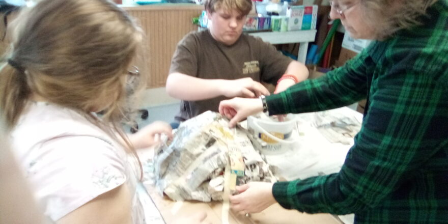 Reggie and Olivia working on their science project. Learning how to assemble a volcano.