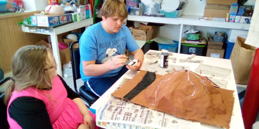 Olivia and Reggie painting their volcano model.