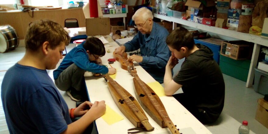 The kids learn how to play their dulcimers with their instructor, Mr. Johanson.