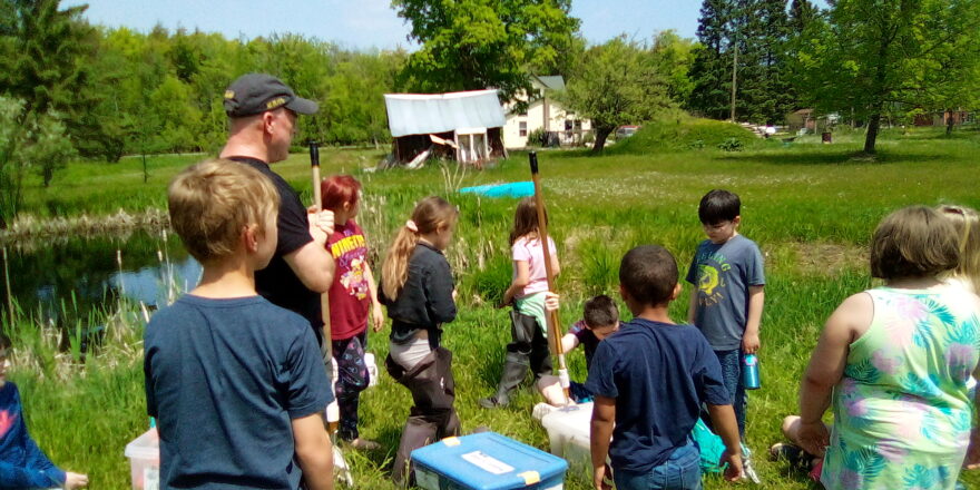 Kids from Arvon and Elm River schools join together and learn about pond life on a field trip.