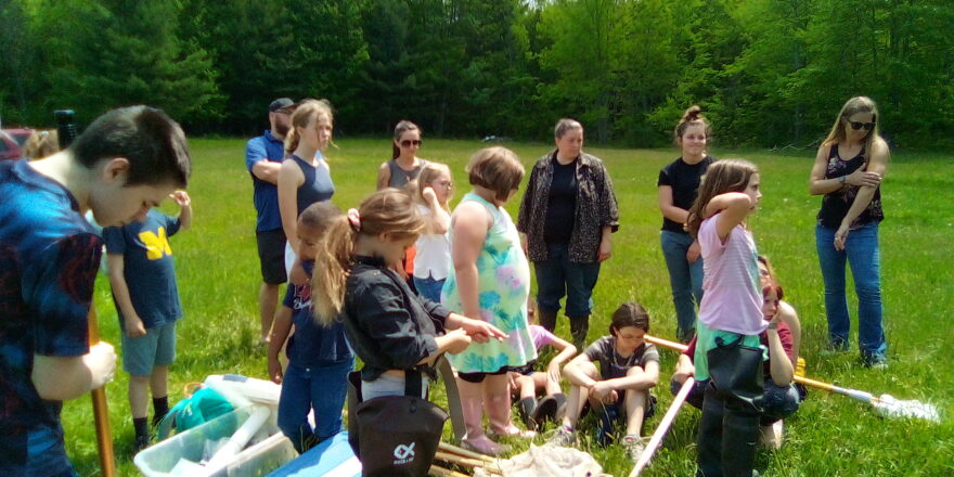 Arvon and Elm River school kids on a micro environment field trip to a pond.