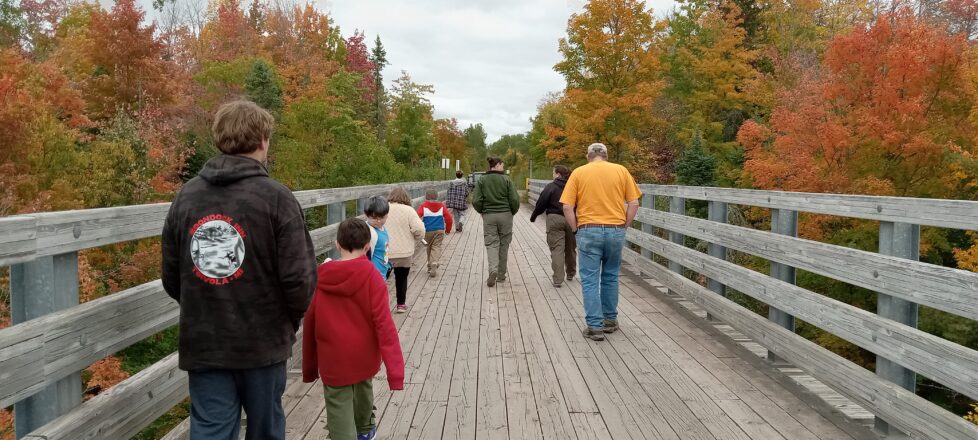 Elm River School kids walking on the trestle bridge to the meeting point where the DNR are giving a lecture.