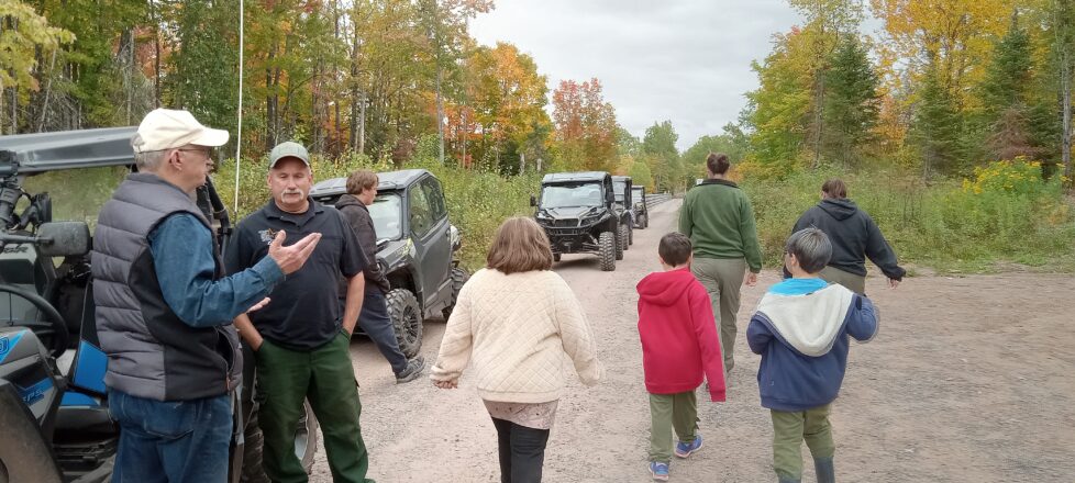 kids walking back to the side by sides from the trestle bridge gathering.