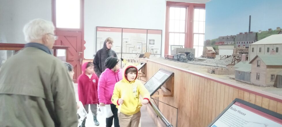 Students looking at all the displays at the Quincy Mine Museum. 