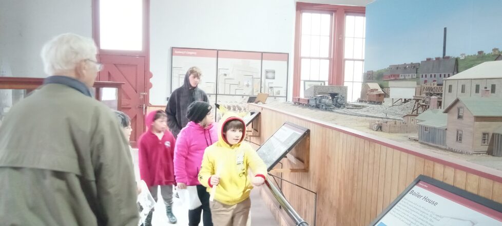 Students looking at all the displays at the Quincy Mine Museum. 