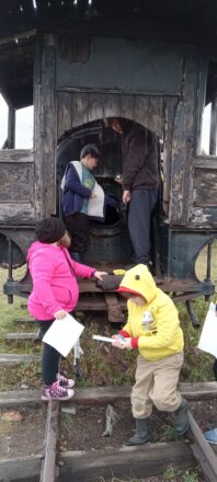 Kids exploring the area around the mine and looking inside the train.