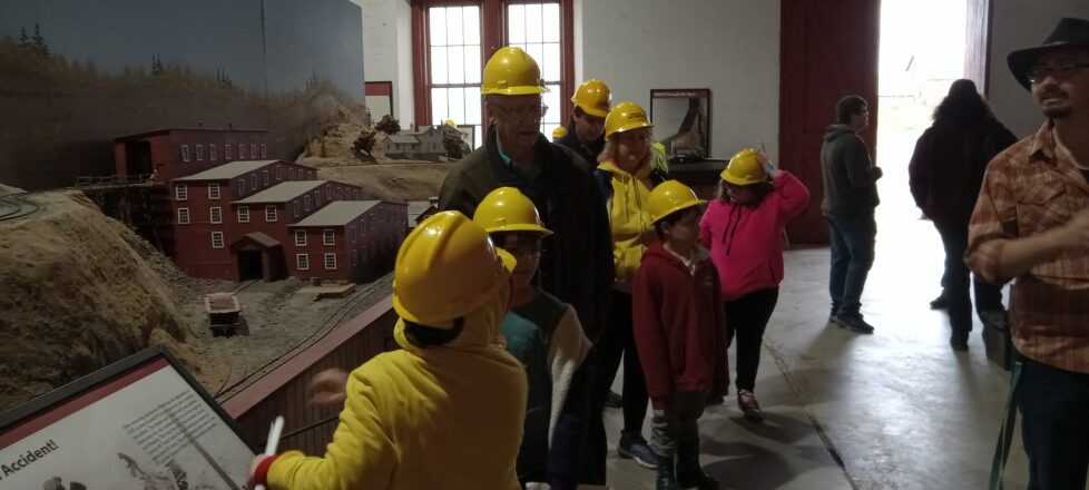 Everyone getting on their safety hard hats for the mine tour.