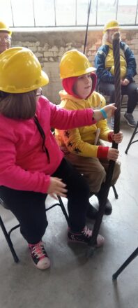 Students holding a piece of the cable that was around the hoist drum. 