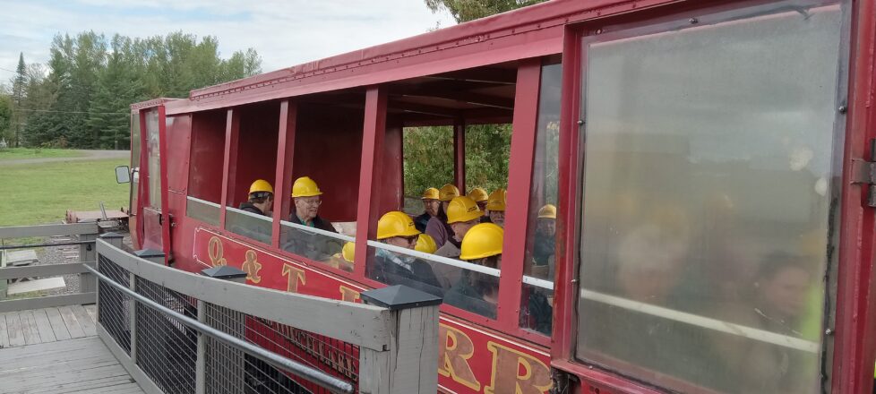 Students sitting in the tram car waiting to be taken down to the mine entrance on the 7th level.