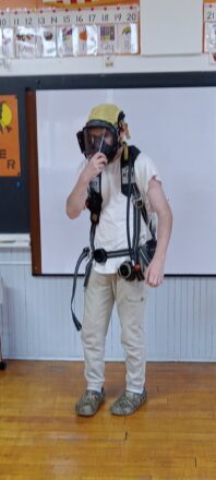 Elm River fire fighters trying to recruit some of the bigger kids by letting them try on air respirator masks.