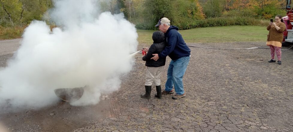 Twin Lakes Fire Dept. teaching the little kids how to point and spray a fire with a home extinguisher.