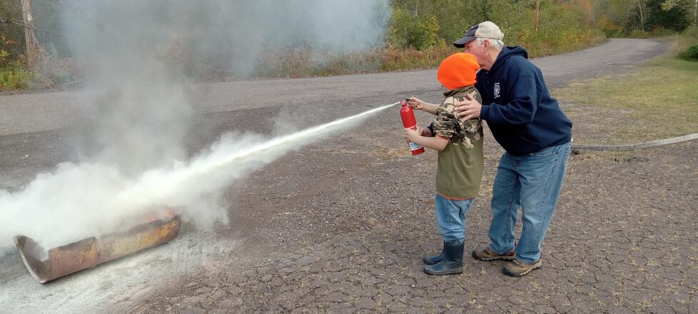 Fire Department teaching each of our kids how to use a fire extinguisher.