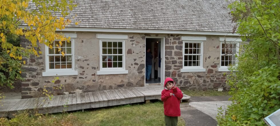 One of the students from Elm River standing outside the main entrance of the light house.