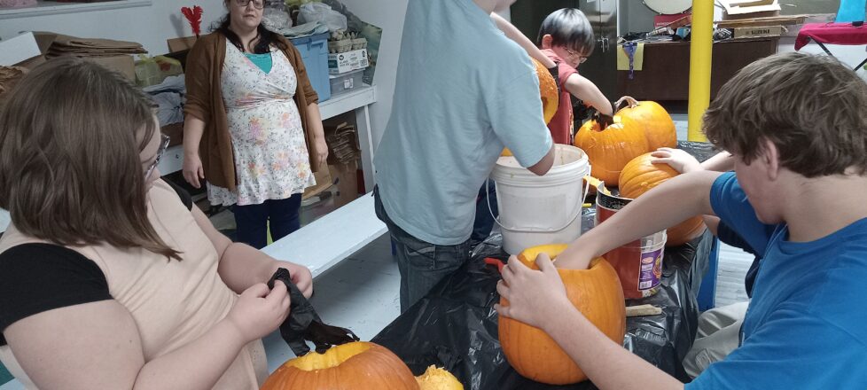 Removing the inside of the pumpkins is such a messy job for the kids, but they like the goey process.