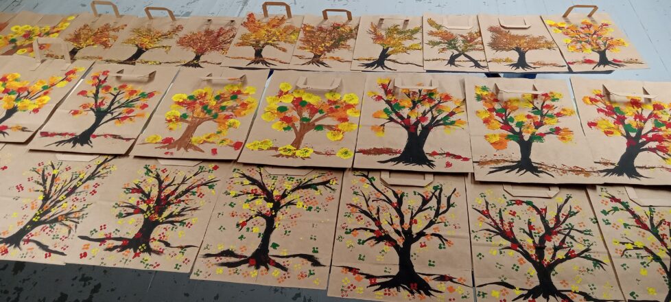 Thanksgiving bags for Friends of the Elderly that the kids decorated. The bag had a painted black or brown tree with multitude of fall colors blotted on the tips for the leaves.