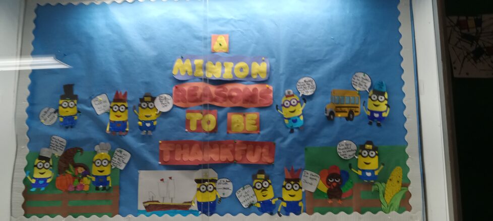 Bulletin board decorated with the minions saying different quotes that they were thankful for. Each minion represents each of the kids and the adults. The heading with them all says, "A minion ways to be thankful."