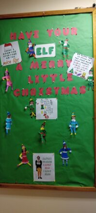 "have your Elf a Merry Little Christmas." Christmas bulletin board nice list with all the kids and staff in pictures of themselves in elf costume cutouts. Elf sign says they stick to the four main food groups: candy, candy canes, candy corn, and syrup.